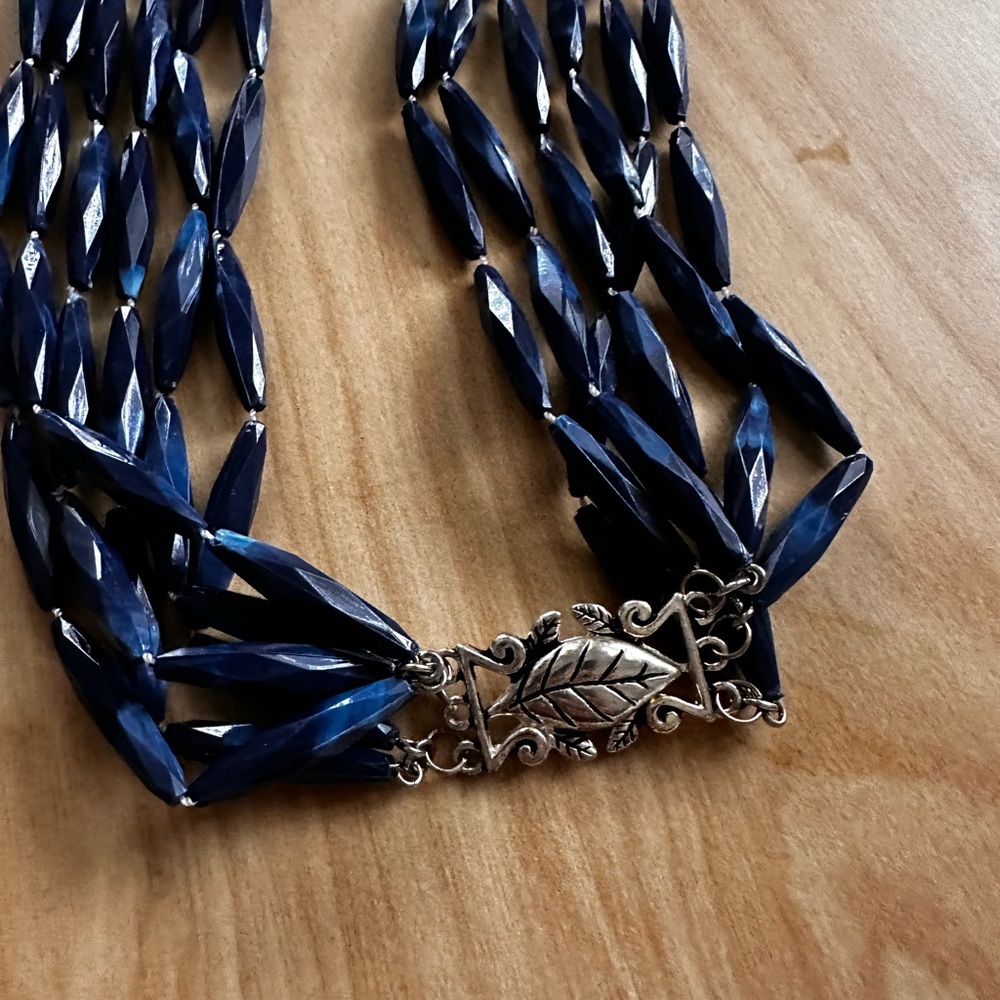 Navy blue long multi strand beaded necklace with Silvertone leaf clasp